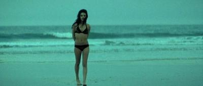 Mila Kunis in bikini on the beach
